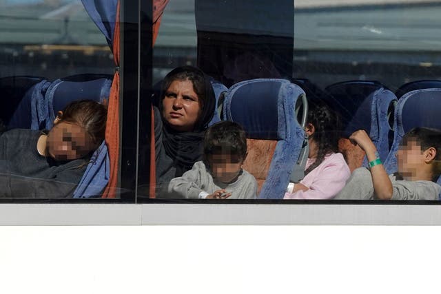 Groups of migrants were put on to buses and driven away from the south coast as Channel crossings continued (Gareth Fuller/PA)