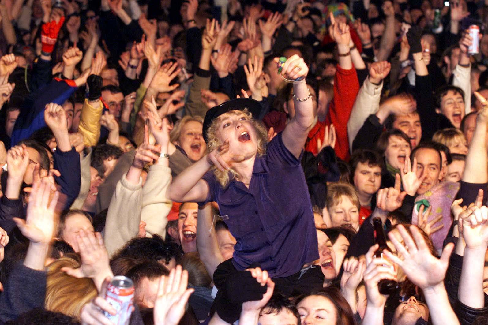 Thousands of revellers outside Belfast City Hall celebrate at the stroke of midnight, as Northern Ireland welcomed in the new Millennium (Paul Faith/PA)