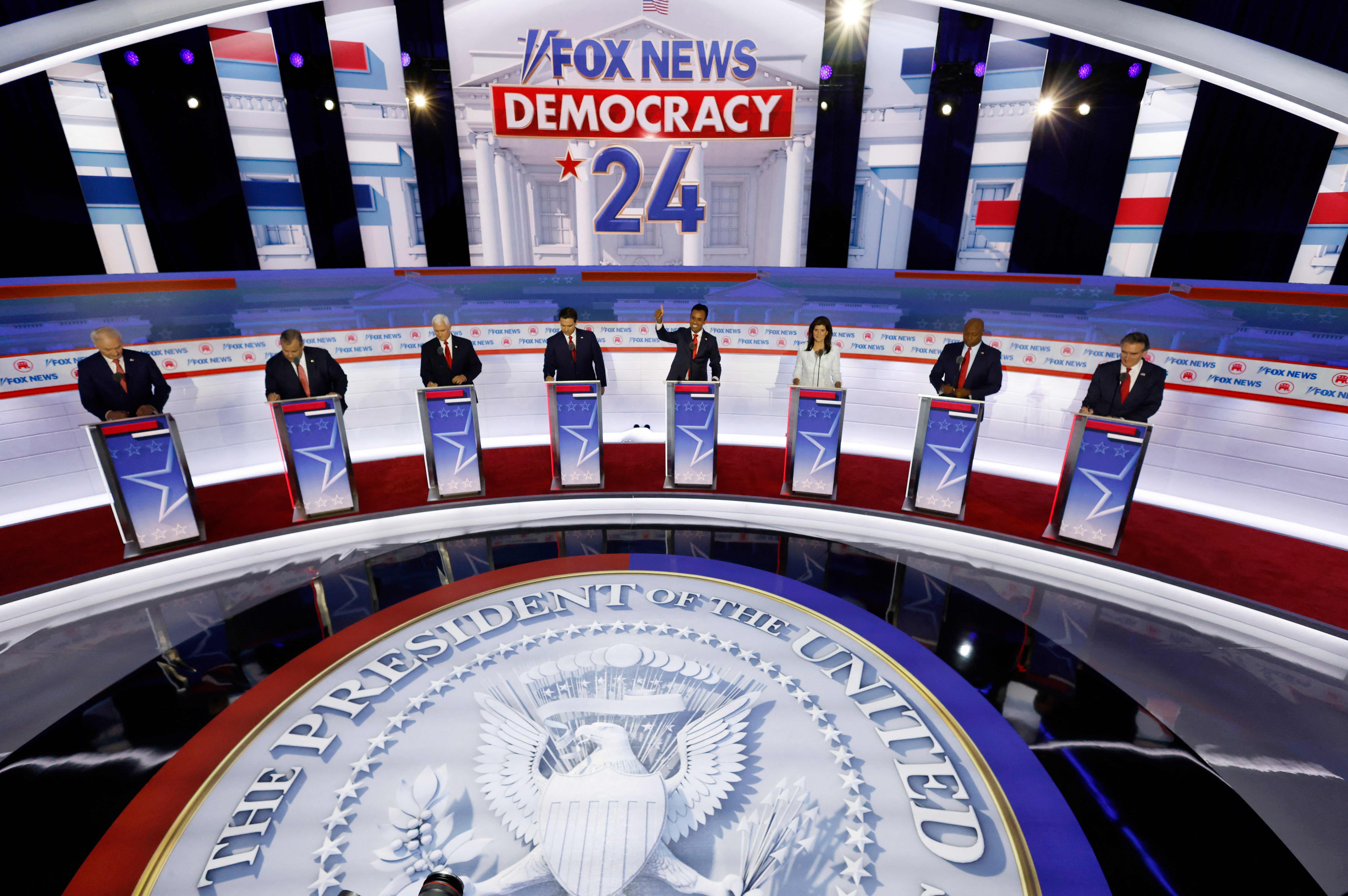 <p>Former Arkansas Governor Asa Hutchinson, former New Jersey Governor Chris Christie, former U.S. Vice President Mike Pence, Florida Governor Ron DeSantis, businessman Vivek Ramaswamy, former South Carolina Governor Nikki Haley, U.S. Senator Tim Scott (R-SC) and North Dakota Governor Doug Burgum stand behind their podiums at the first Republican candidates' debate of the 2024 U.S. presidential campaign in Milwaukee, Wisconsin</p>