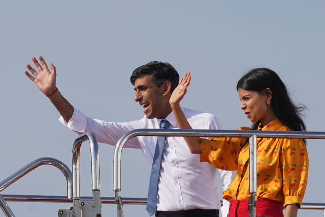 <p>Prime Minister Rishi Sunak and wife Akshata Murty wave as they board a plane (Stefan Rousseau/PA)</p>