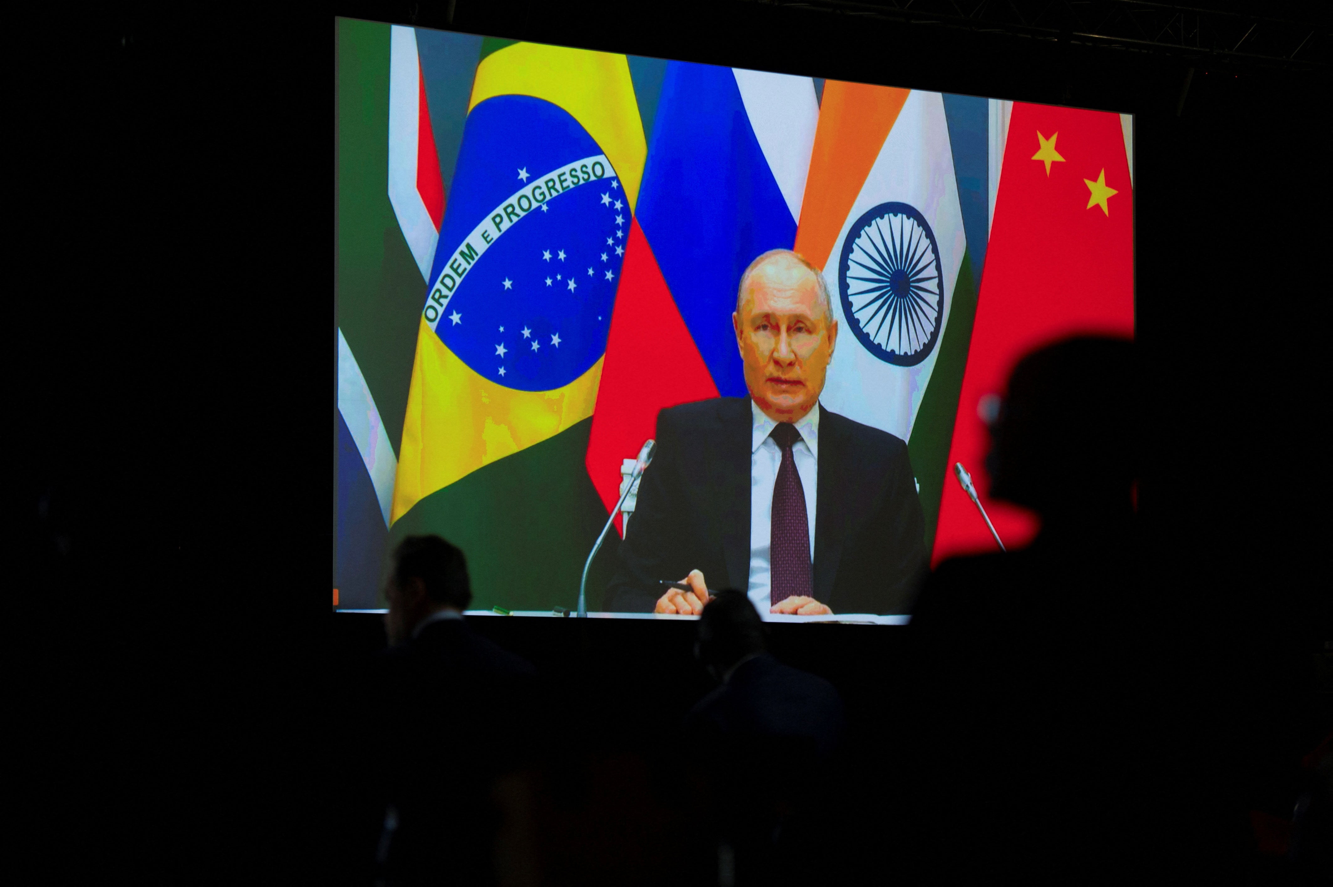 Russian president Vladimir Putin speaks via video link during a press conference