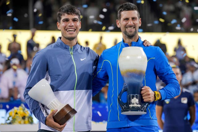 Novak Djokovic, right, beat Carlos Alcaraz in Cincinnati (Aaron Doster/AP)