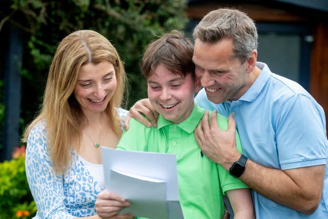 Seb Murphy, 16, celebrates his GCSE results with parents Helen and Ben after battling health problems (Bradford Grammar School/PA)