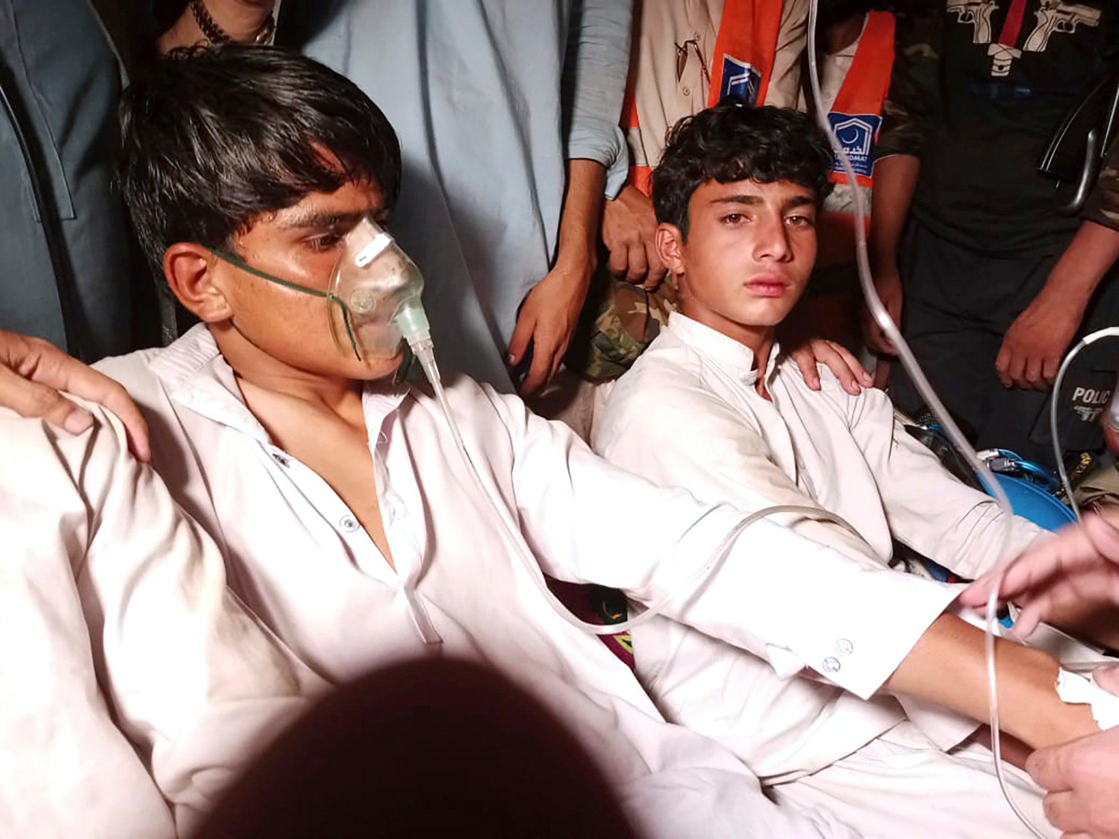 Youngsters who were trapped in a broken cable car, receive first aid following their rescue, in Pashto village, a mountainous area of Battagram district in Pakistan’s Khyber Pakhtunkhwa province