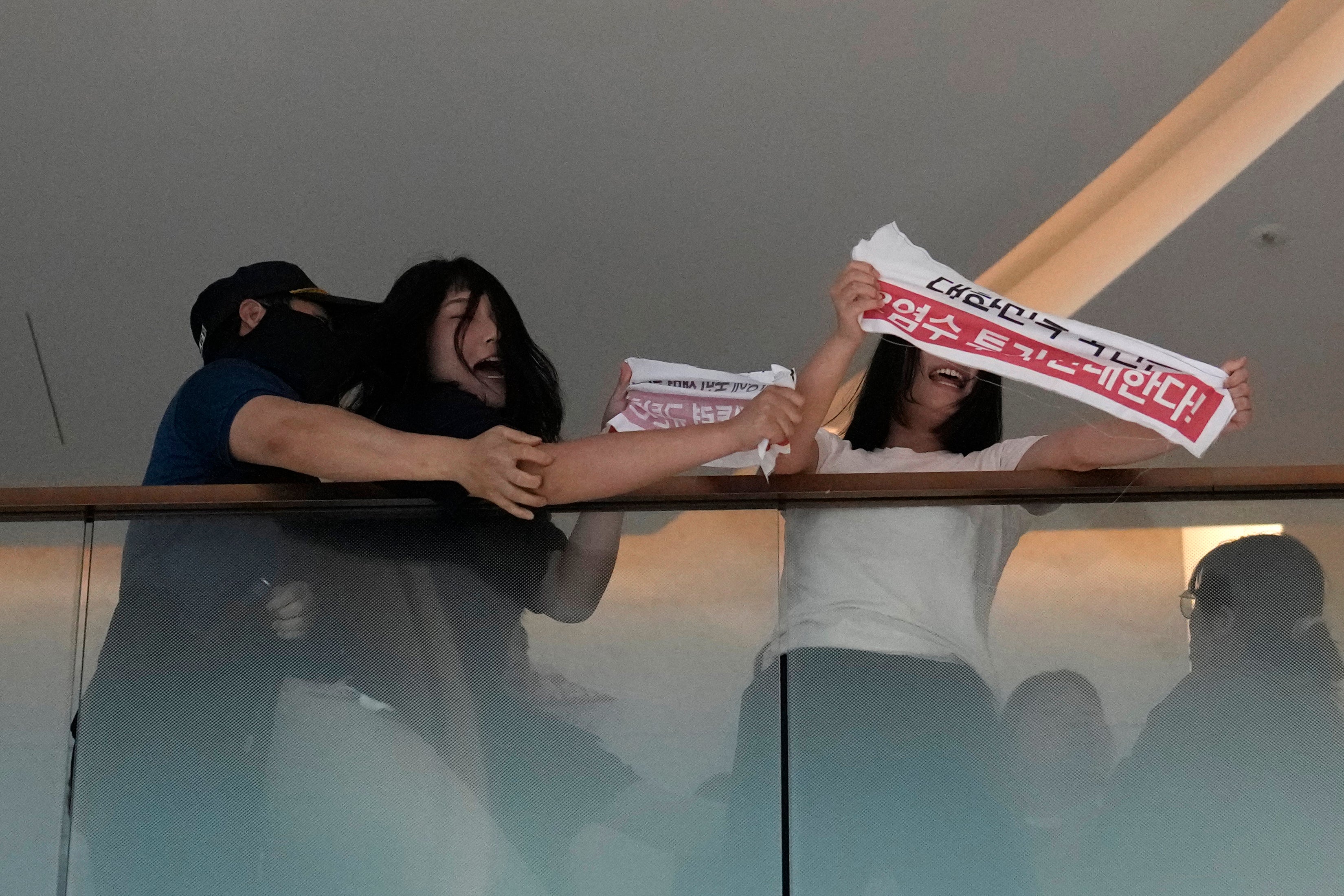 Police grapple with students attempting to break into the Japanese embassy in Seoul