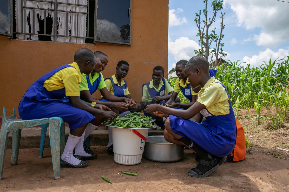Primary school girls wash okra growing in their school garden in South Sudan as part of WFP-supported school meals