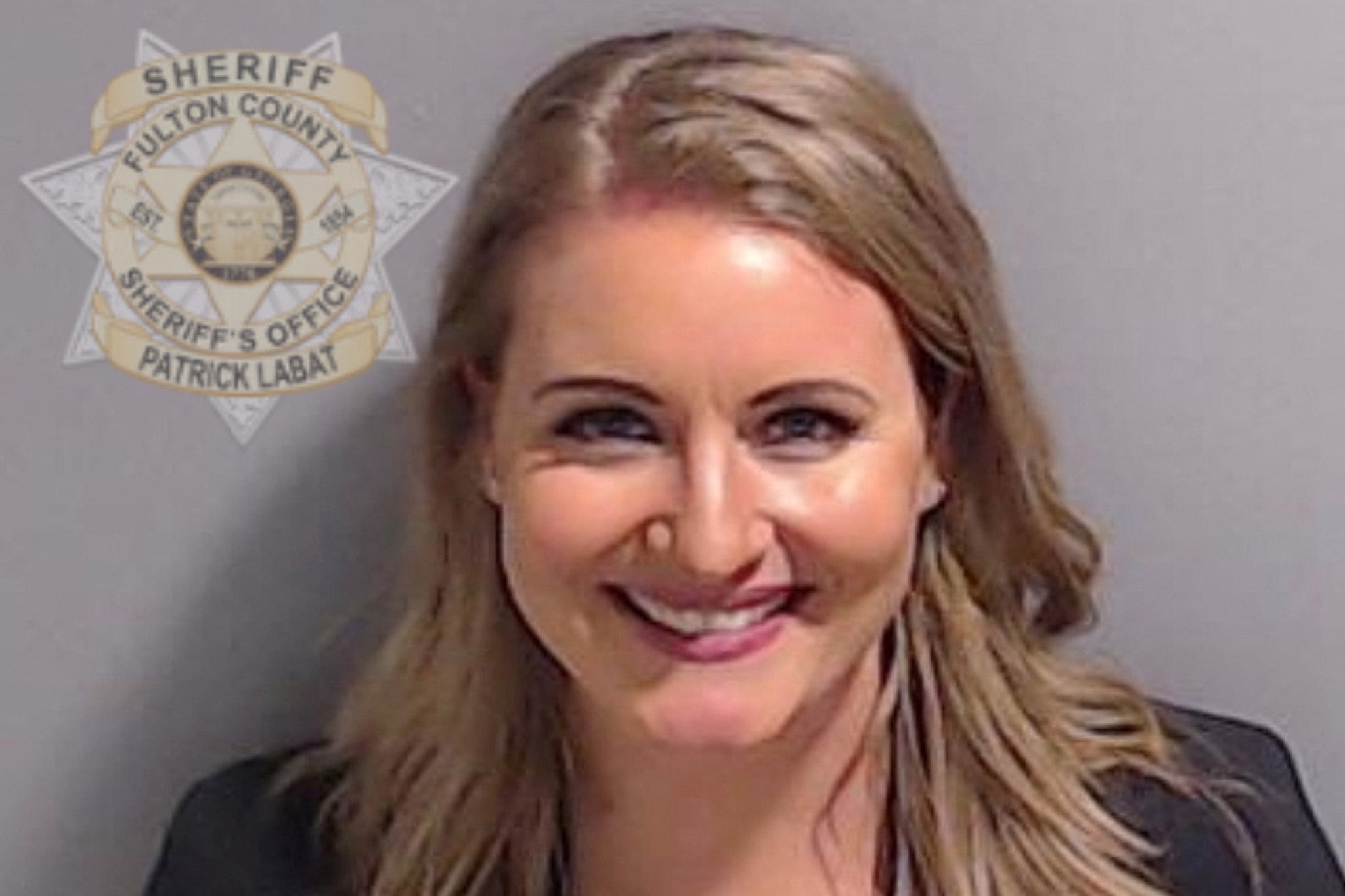 A beaming Jenna Ellis in a booking photo taken in Fulton County in August