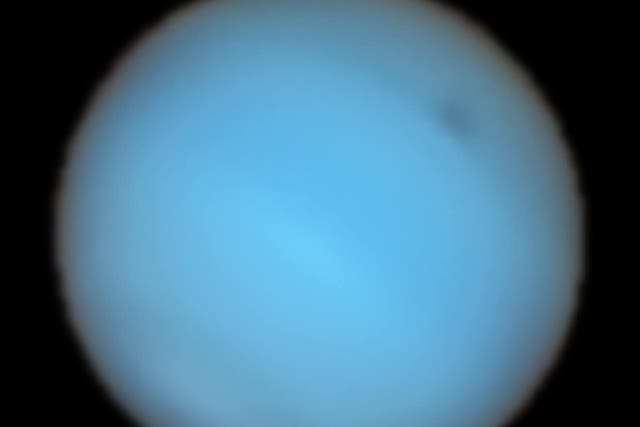 astronomers have seen a large dark spot in Neptune’s atmosphere (P Irwin et al/ESO/PA)