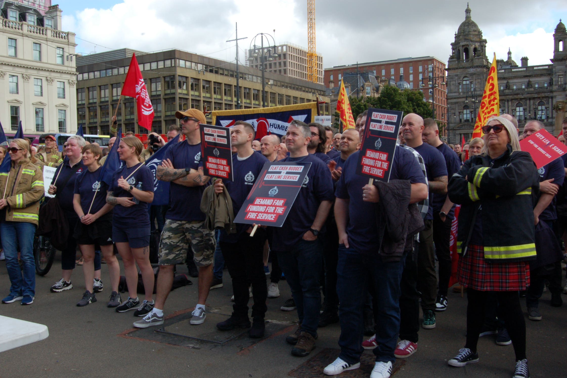 Firefighters staged a rally against cuts to fire service funding proposed by the Scottish Government (PA)