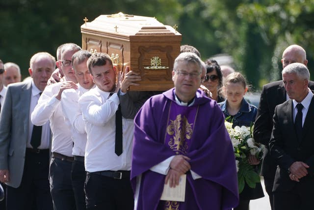 Father Gerry Boyle walks in front of the coffin of Brendan Wall as it is carried from the Church of St Brigid in Grangegeeth, Co Meath, following his funeral mass (Brian Lawless/PA)