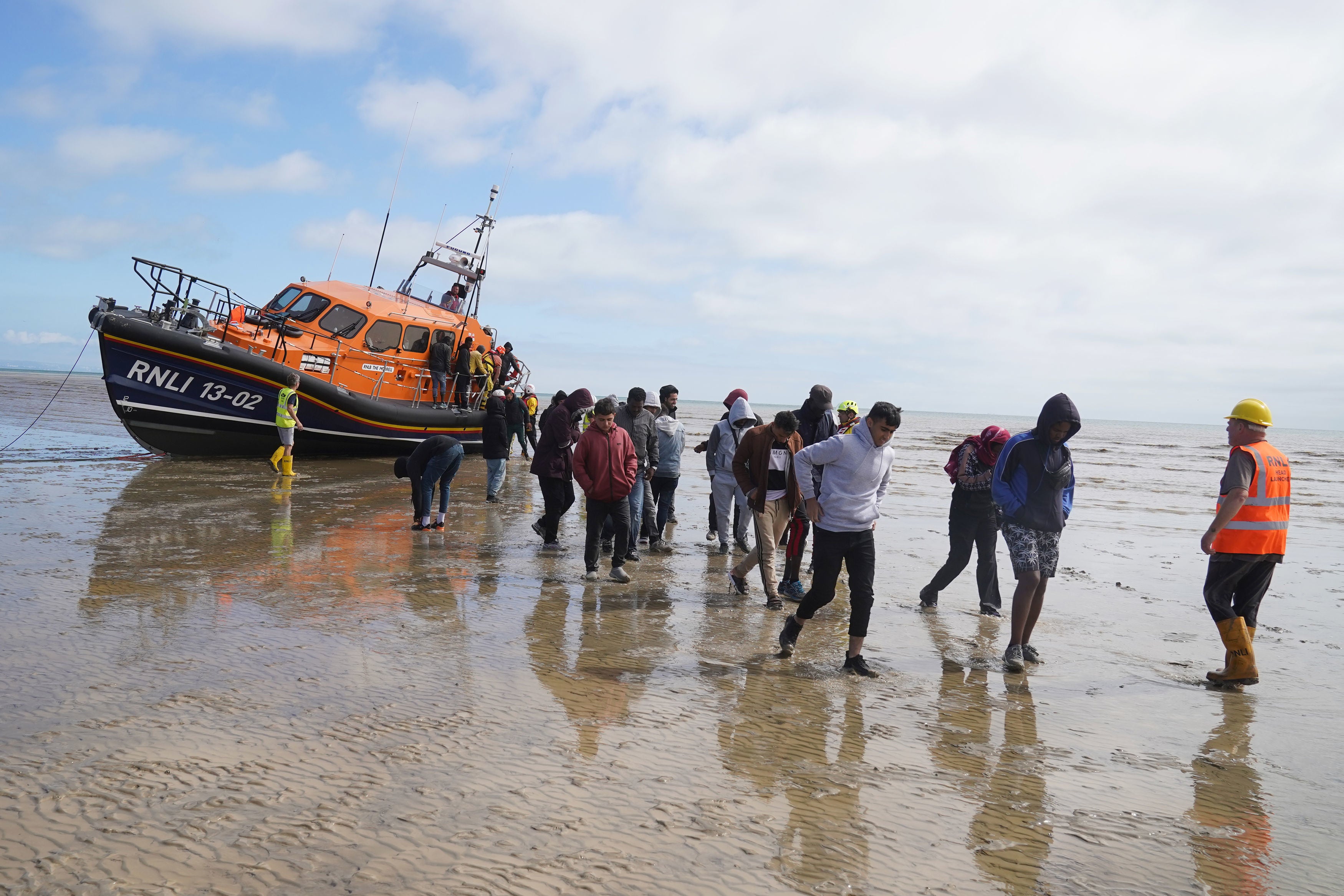 Migrants rescued in the English Channel in August are brought onshore at Dungeness, Kent