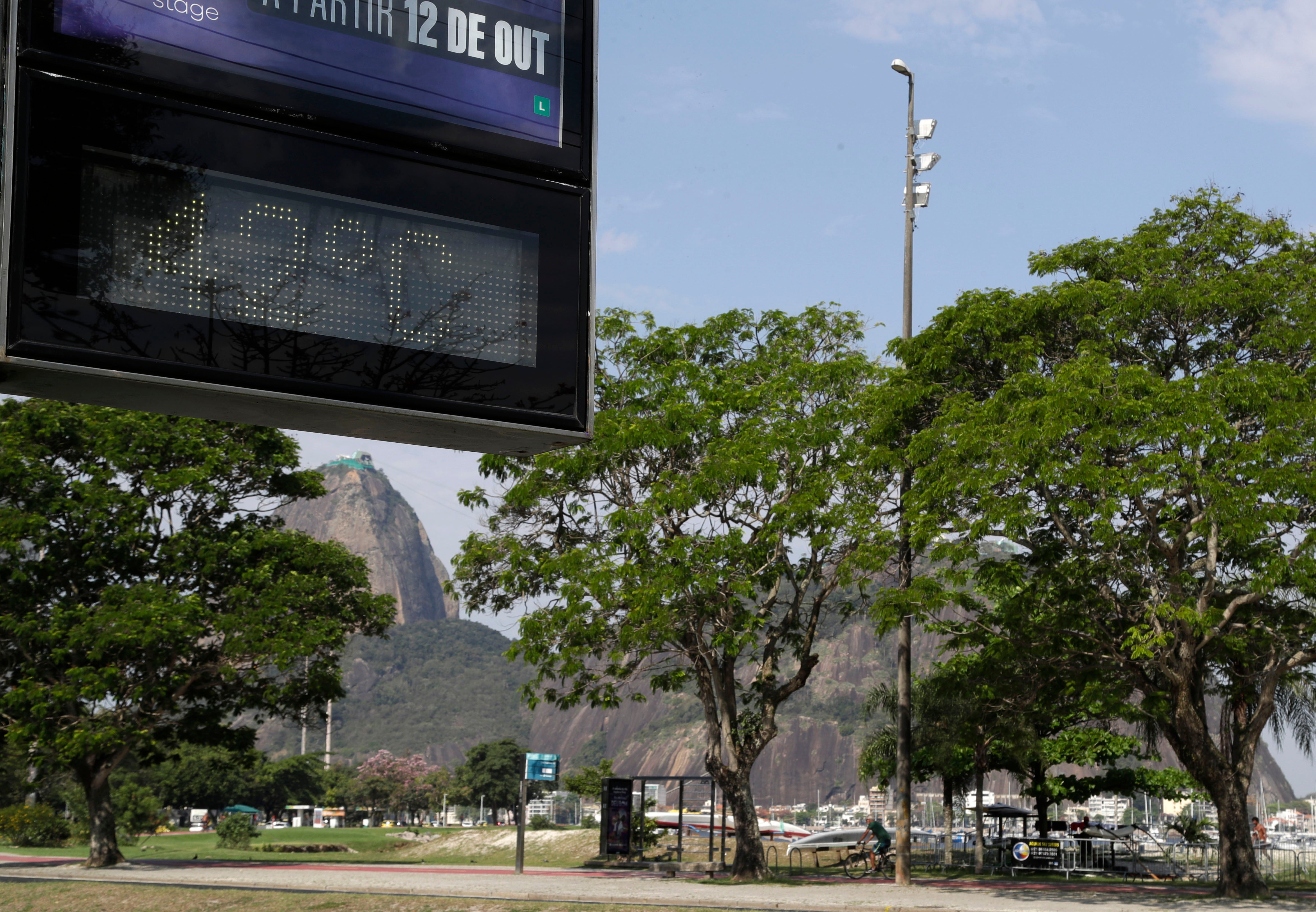 A digital sign displays the temperature at 42C in Rio de Janeiro, Brazil