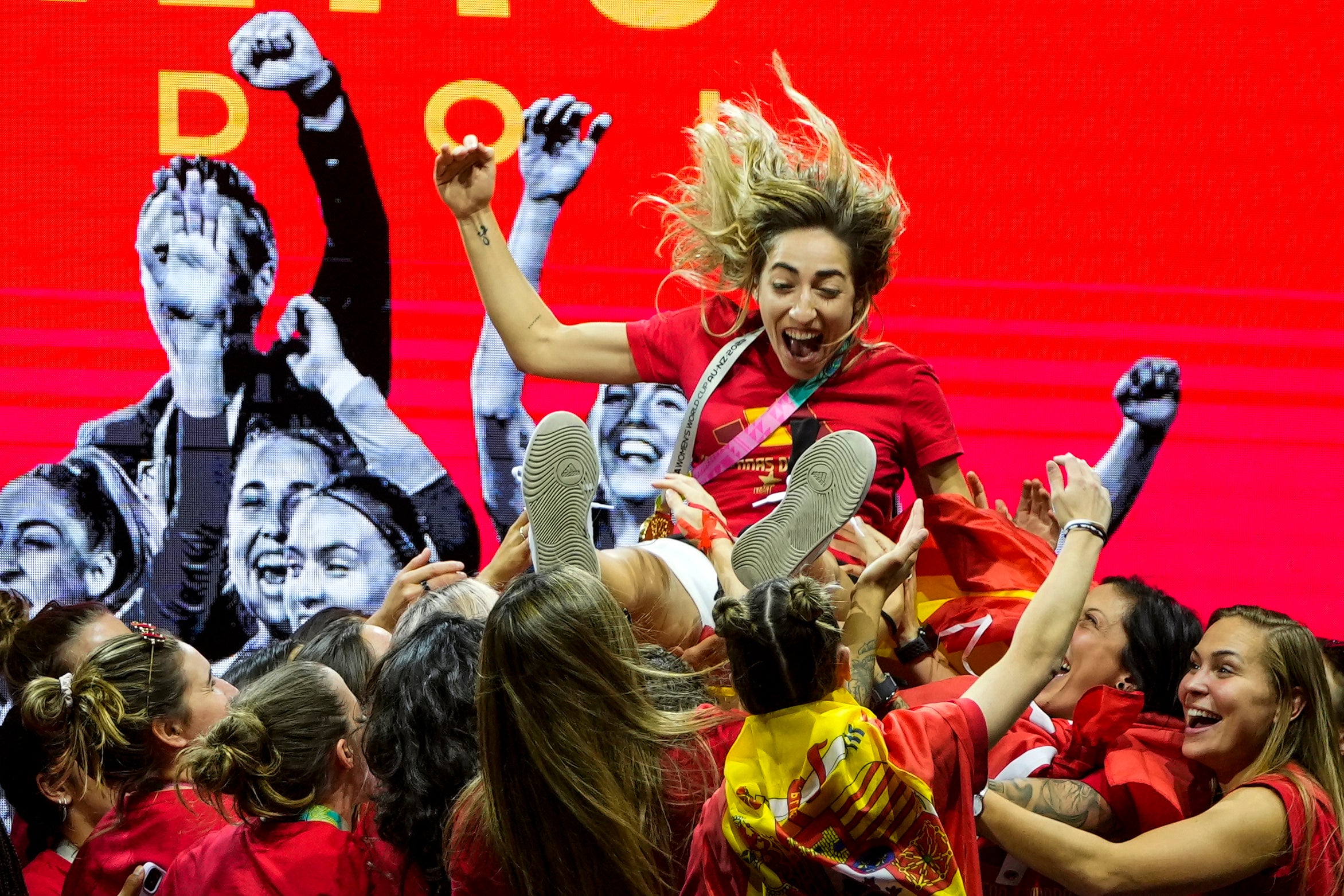 Olga Carmona is thrown in the air by her Spanish teammates