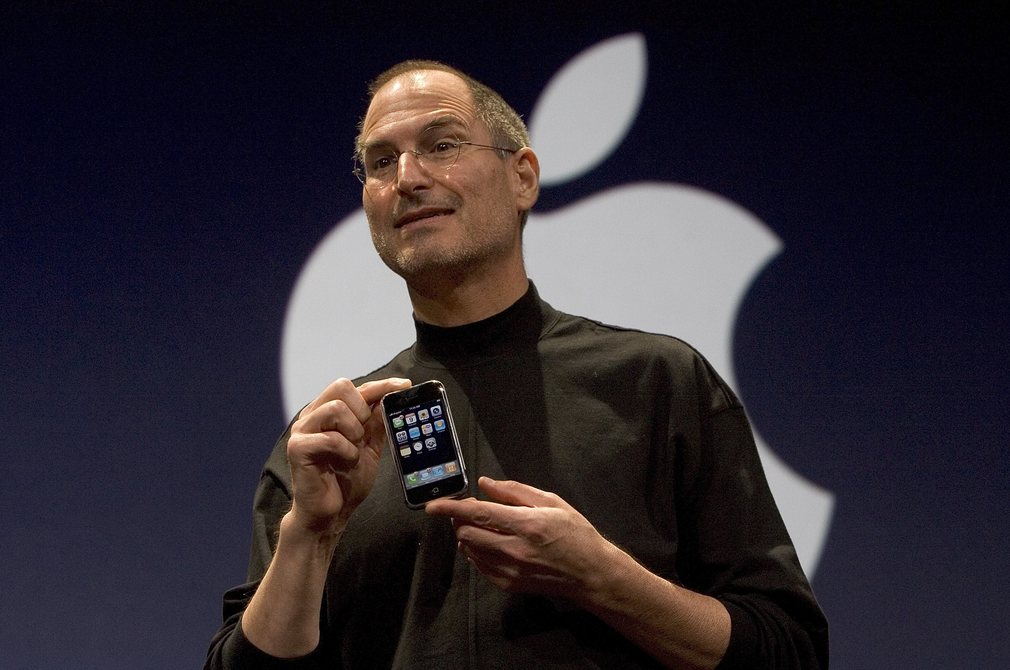 Apple CEO Steve Jobs holds up the new first-generation iPhone on 9 January 2007 in San Francisco. Apple has always been troubled by issues of efficiency and price, and that concern was the basis of its relationship with Arm from the beginning