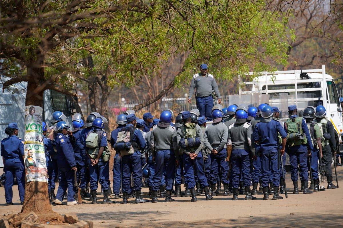 Zimbabweans anxiously wait for election results as armed police gather with water cannons