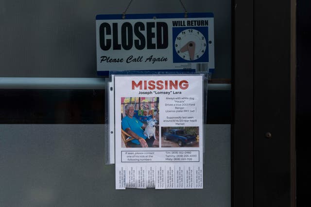 <p>A missing person flyer for Joseph "Lomsey" Lara is posted on the door of a business in a shopping mall in Lahaina, Hawaii, Monday. Officials released the names of 388 people still unaccounted for after the blazes two weeks ago </p>