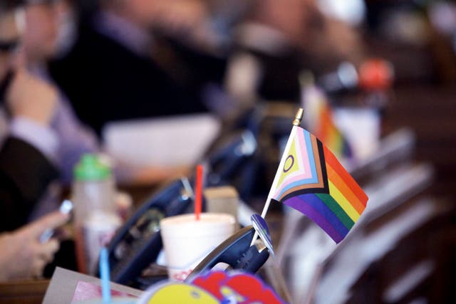 <p>File photo of a flag supporting LGBT+ rights decorates a desk on the Democratic side of the Kansas House of Representatives during a debate, 28 March 2023, at the Statehouse in Topeka, Kansas</p>