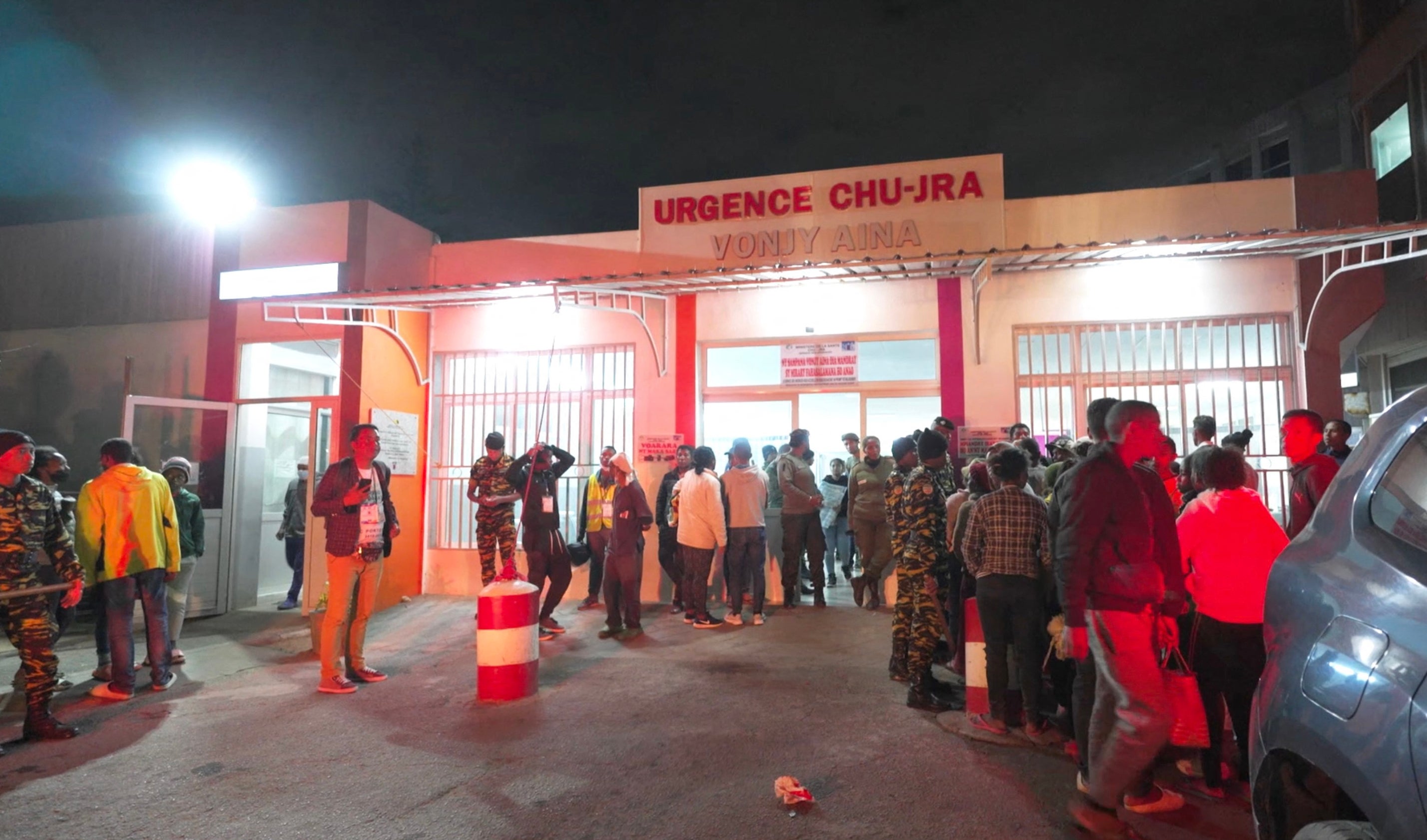 This videograb shows people outside the HJRA (Hopital Joseph Ravoahangy Andrianavalona) public hospital emergency building in Antananarivo following a stampede at a stadium