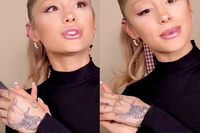 <p>Ariana Grande debuts her new hand tattoo in a video for her cosmetics brand, REM Beauty</p>