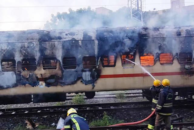 <p>Firefighters try to extinguish a fire which broke out in a train coach parked at the Madurai railway yard, in Madurai</p>