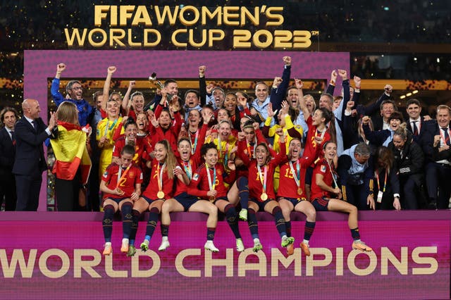 <p>Spain’s players and coaches celebrate their World Cup win – as Luis Rubiales, left, joins in</p>