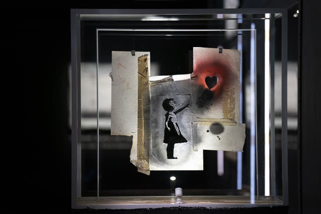 The original stencil piece of the girl with the heart balloon on display at Banksy’s Cut & Run at Glasgow’s GoMA (Jane Barlow/PA)