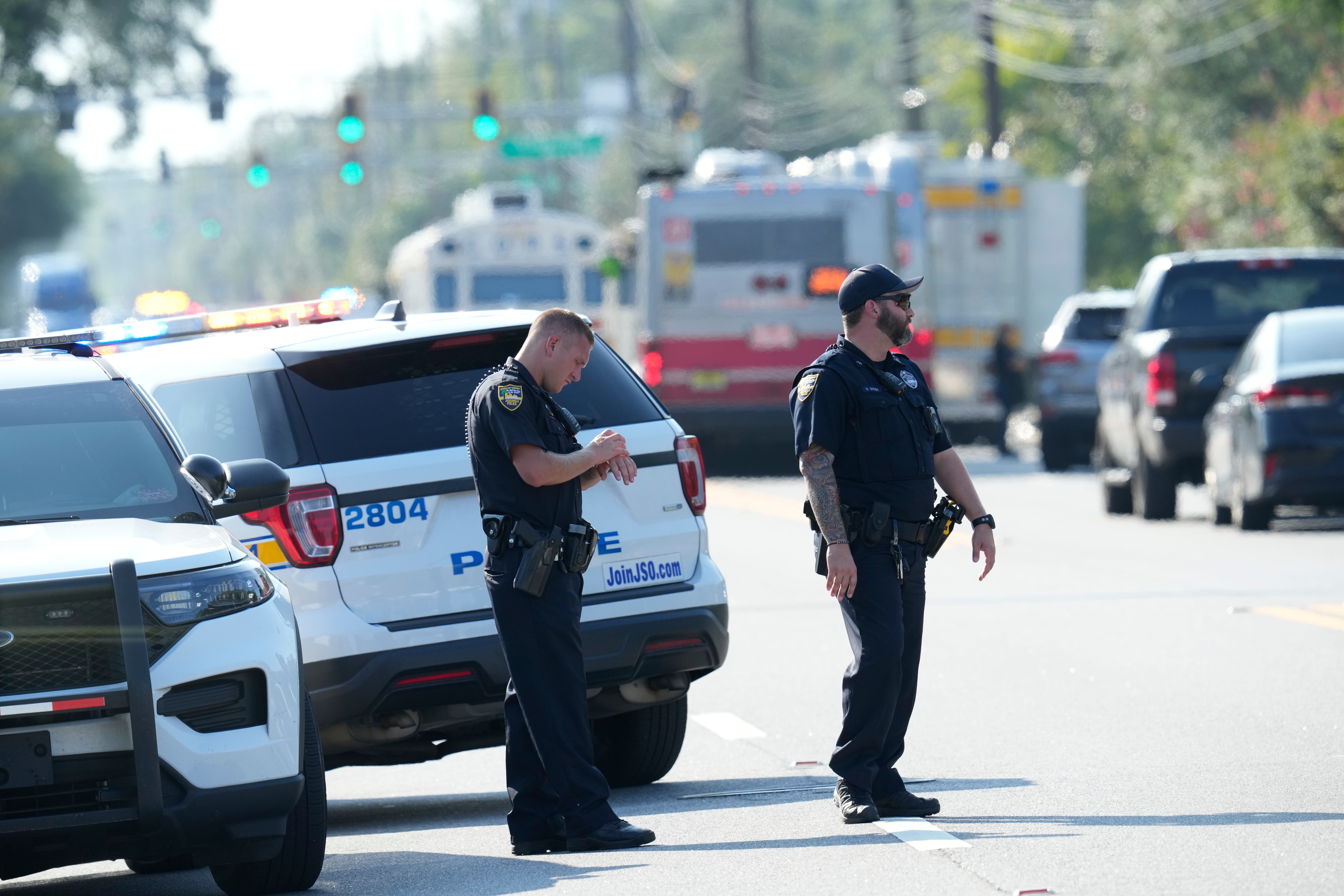 Jacksonville police officers block the perimeter of the scene of a mass shooting, Saturday, Aug. 26, 2023, in Jacksonville, Fla.