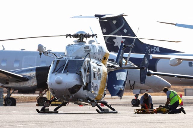 <p>A Care Flight helicopter is seen on the tarmac of the Darwin International Airport in Darwin as rescue work is in progress to transport those injured in the US Osprey military aircraft crash at a remote island north of Australia’s mainland</p>