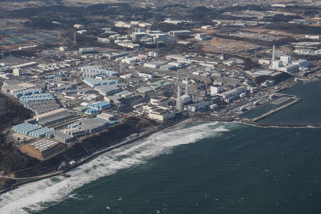 <p>A view of Tepco’s crippled Fukushima Daiichi Nuclear Power Plant as well as tanks (L) used for storing treated wastewater, along the coast in Okuma, Fukushima prefecture</p>