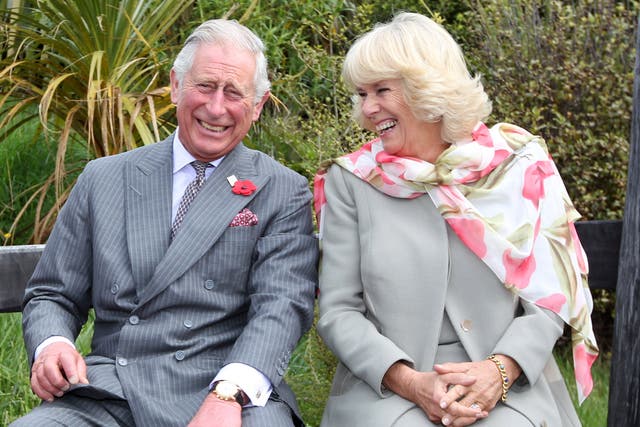 <p>King Charles, then-Prince of Wales and Queen Camilla, then-Duchess of Cornwall continue to laugh after a bubble bee took a liking to Prince Charles during their visit to the Orokonui Ecosanctuary on November 5, 2015</p>