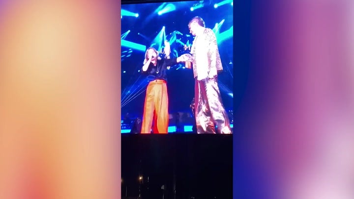 <p>Robbie Williams and Mark Owen reunite on stage for the first time in 12 years.</p>