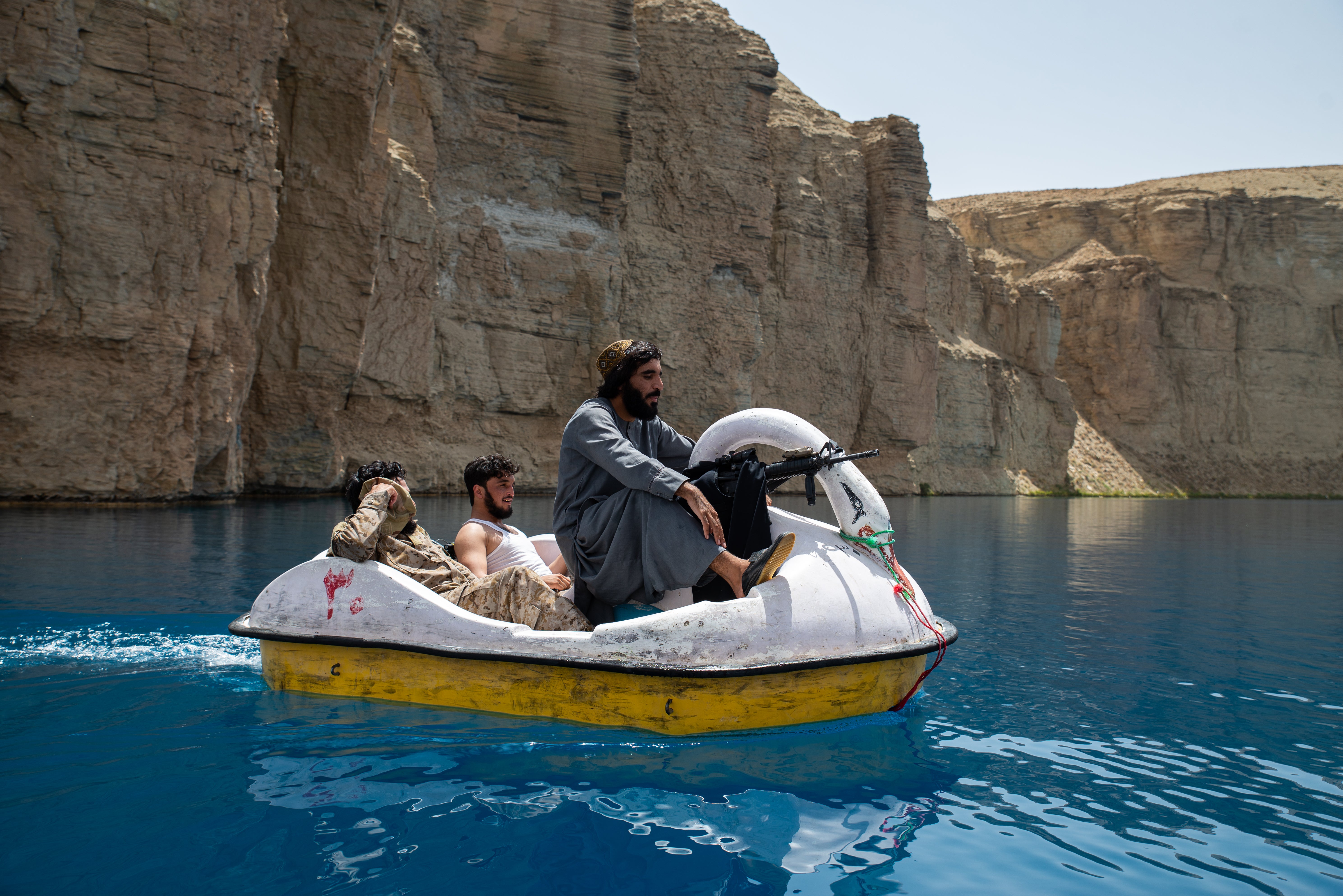 Taliban members paddle in a boat as they and Afghan families enjoy a visit to one of the lakes in Band-e Amir national park, a popular week-end destination