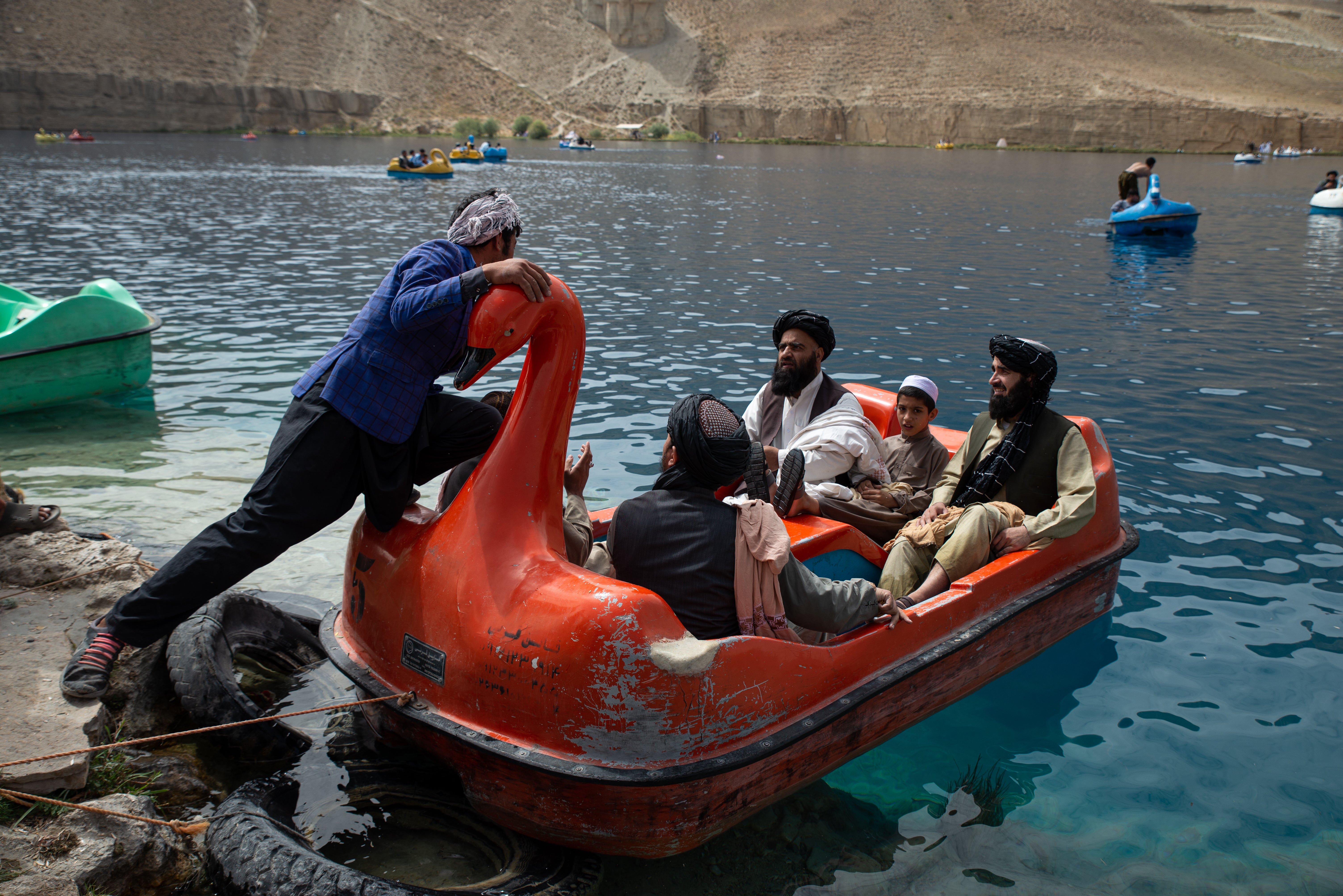 Afghan families and Taliban members visit one of the lakes in Band-e Amir national park, a popular week-end destination, on August 12, 2022