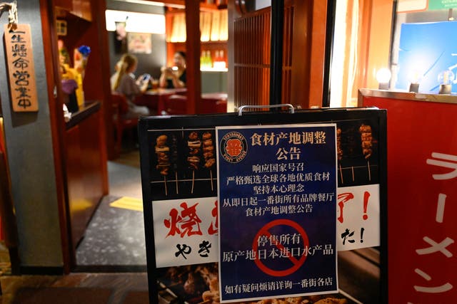 <p>File. This picture shows a sign reading ‘suspend the sale of all fish products imported from Japan’ in an area of Japanese restaurants in Beijing, China </p>