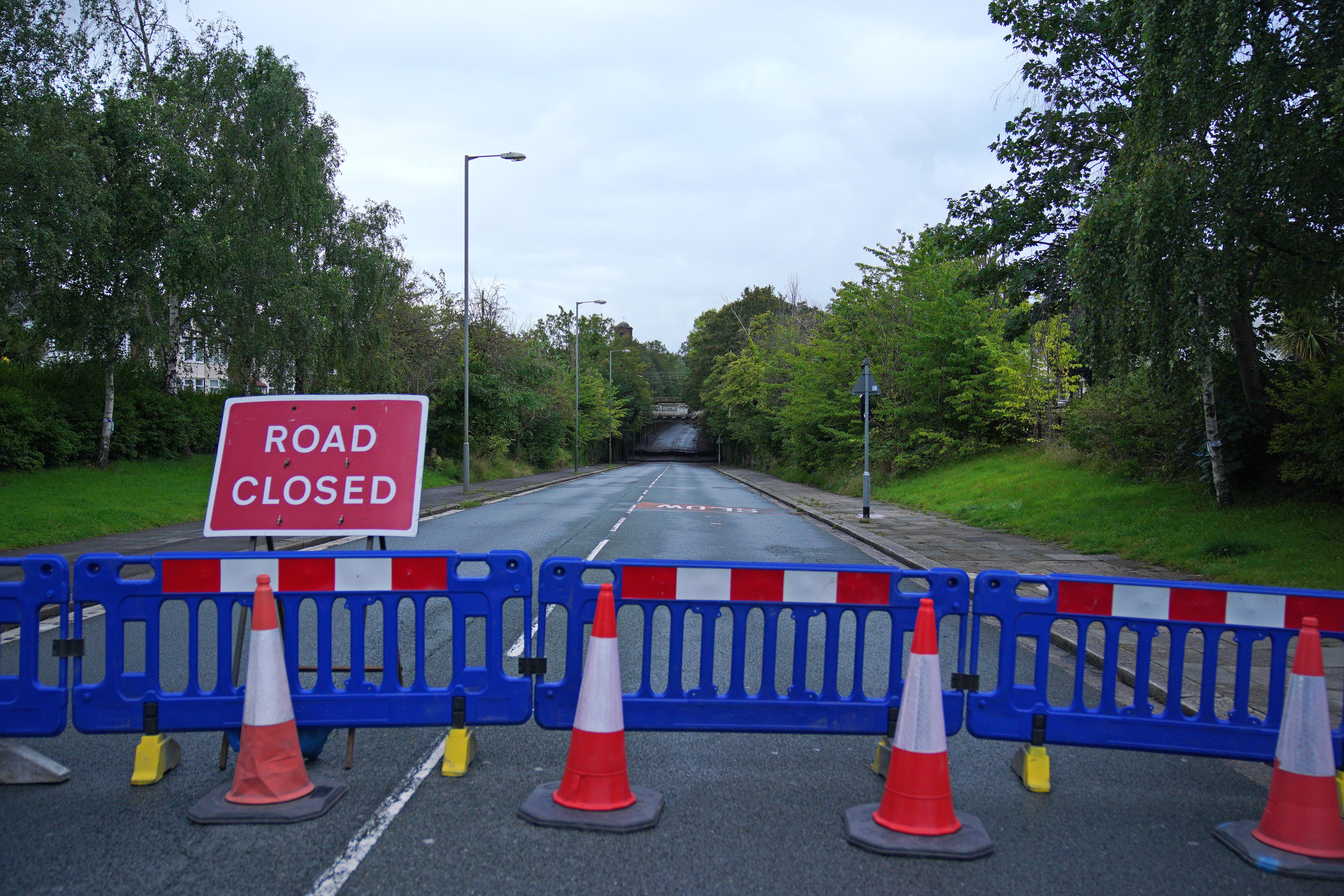 Road closures are in place after two people died in a flooding