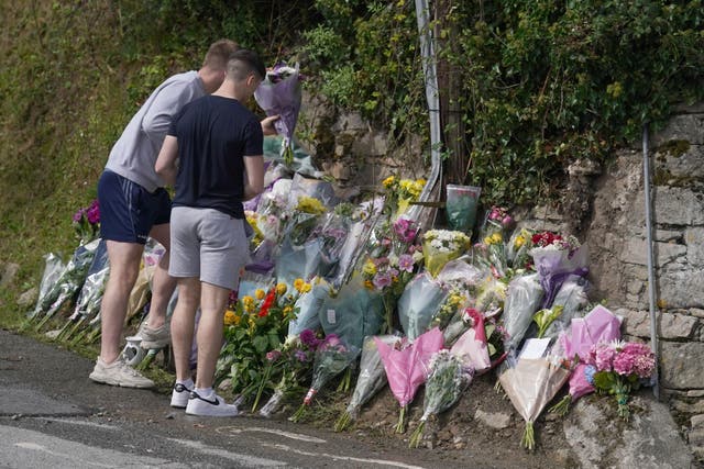 Flowers and tributes left at the scene in Clonmel where four young people died in a car crash (Brian Lawless/PA)