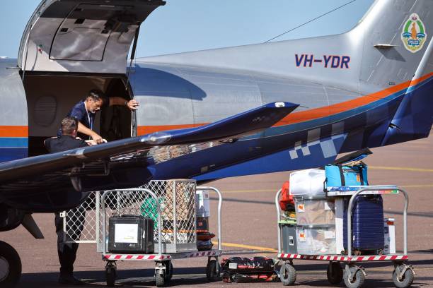 Police personnel load equipments onto a Northern Territory Police plane on the tarmac of the Darwin International Airport in Darwin on 28 August 2023