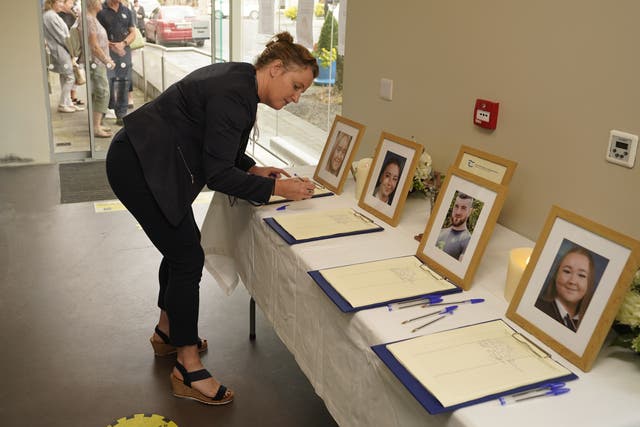 Members of the public queue up to sign the book of condolence at County Hall, Clonmel (Niall Carson/PA)