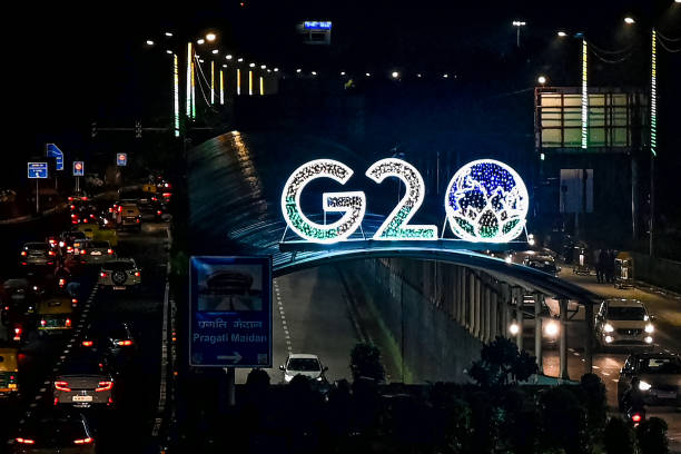 Vehicles drive past the logo of India’s G20 summit, along a road in New Delhi on 10 August 2023