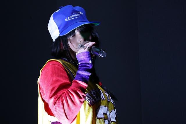 <p>Dressed in bright baseball garb, Billie Eilish performs at this year’s Reading Festival </p>