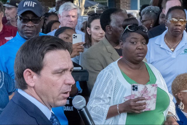 <p>Ron DeSantis speaks at a prayer vigil after a white man armed with a rifle and a handgun killed three Black people at a Dollar General store in Florida</p>