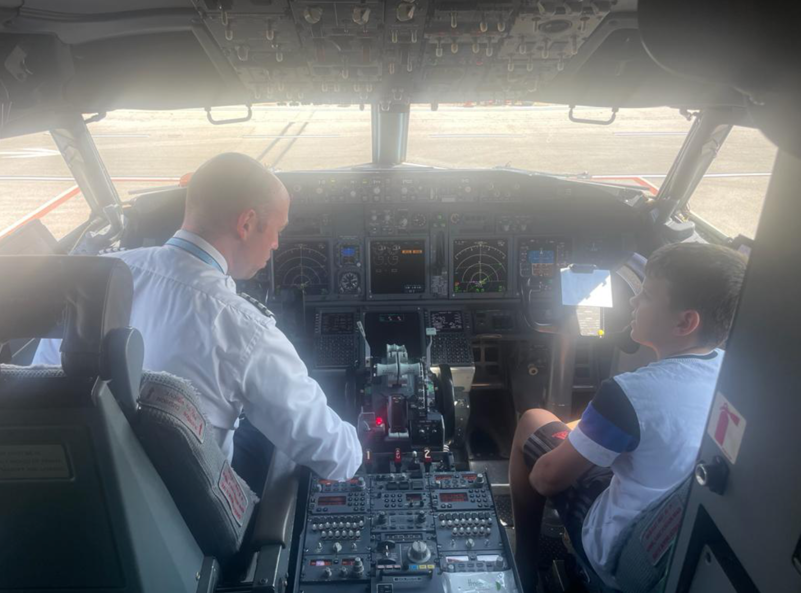 11-year-old Danny was ‘over the moon’ to be shown round the cockpit as the Magarottos’ flight was held on the tarmac