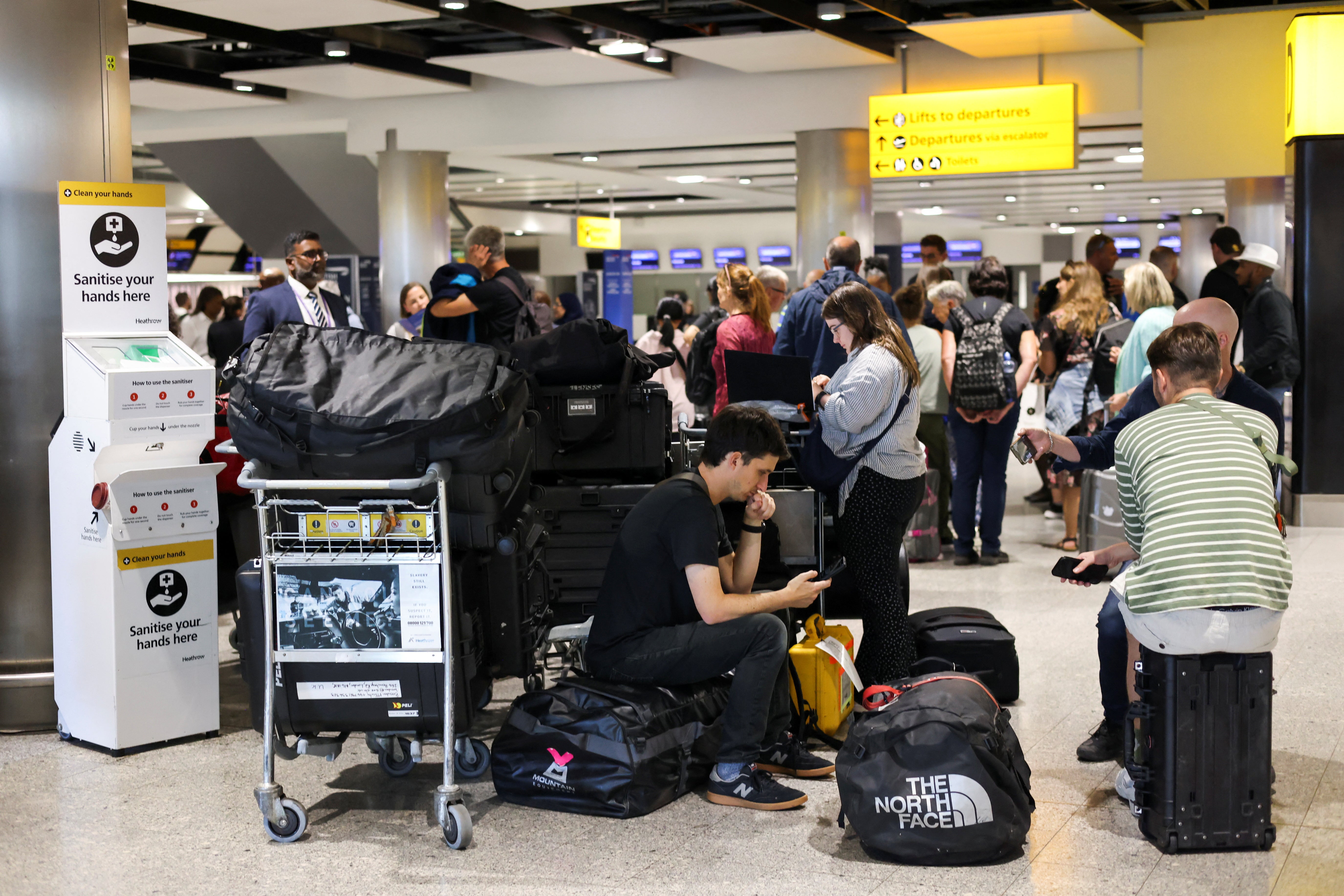 Travellers wait near the British Airways check-in area at Heathrow Airport, as Britain’s National Air Traffic Service (Nats) restricts UK air traffic due to a technical issue causing delays, in London, Britain, 28 August 2023