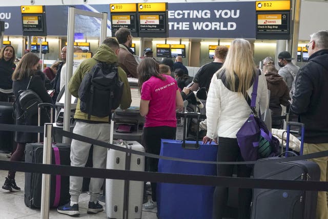 People queuing to check-in at Heathrow Terminal 2. Picture date: Monday April 4, 2022.
