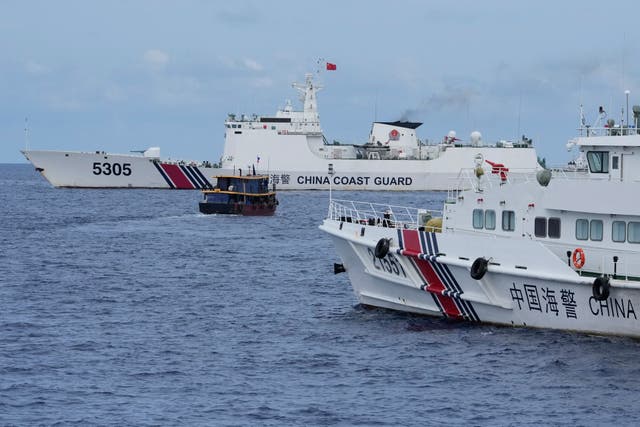 <p>File photo: Philippine supply boat, centre, maneuvers around Chinese coast guard ships as they tried to block its way near Second Thomas Shoal, locally known as Ayungin Shoal, at the disputed South China Sea on 22 August 2023</p>