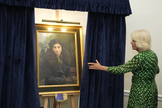 The Queen unveils a portrait of special operations executive (SOE) operative, Noor-un-Nisa Inayat Khan GC, and formally announces the naming of a room in her honour at the Royal Air Force Club in Piccadilly (Kirsty Wigglesworth/PA)