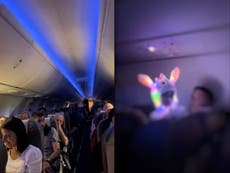 Child wearing glow-in-the-dark light-up hat disrupts plane passengers in viral video