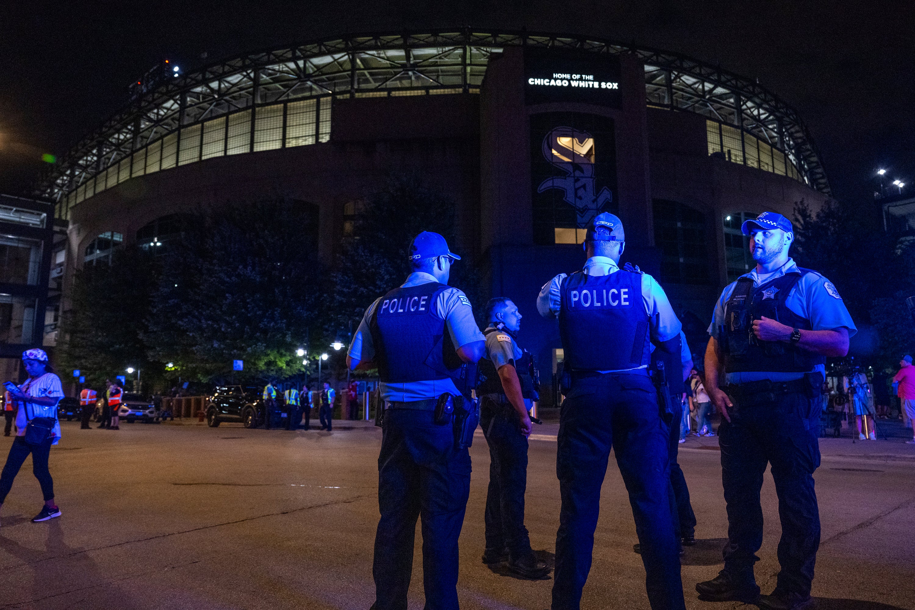 Chicago police officers stand outside Guaranteed Rate Field. Police are investigating a shooting at the White Sox's baseball game at the stadium Friday night