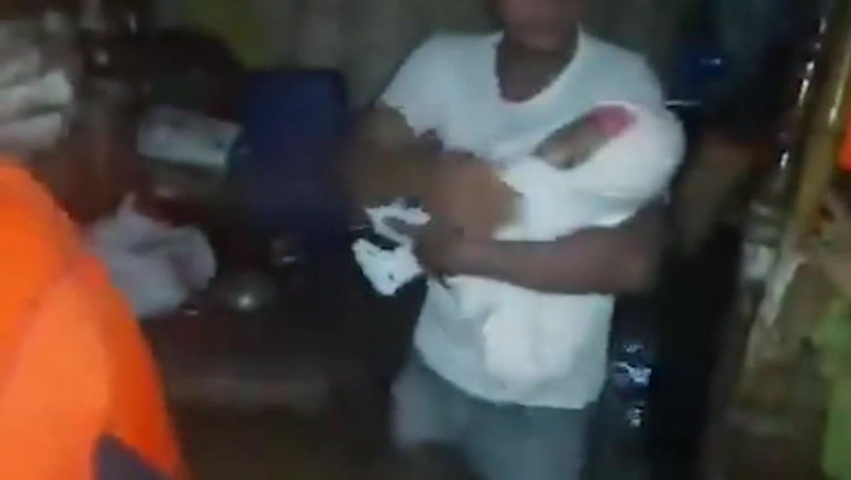 Coastguard rescues family with baby as Super Typhoon Saola floods homes in the Philippines