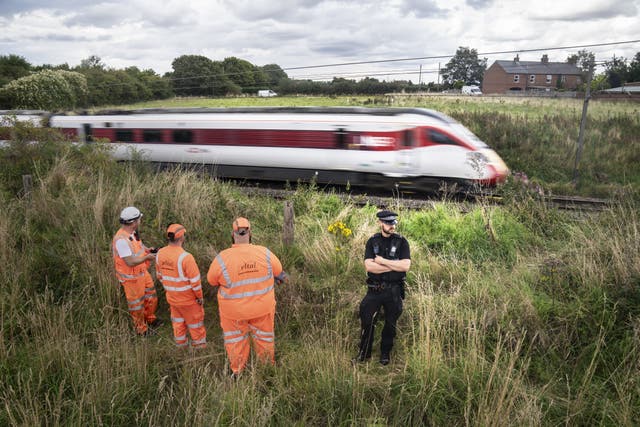 Police and railway workers near the scene in Balderton, near Newark-on-Trent. Picture date: Friday August 25, 2023.